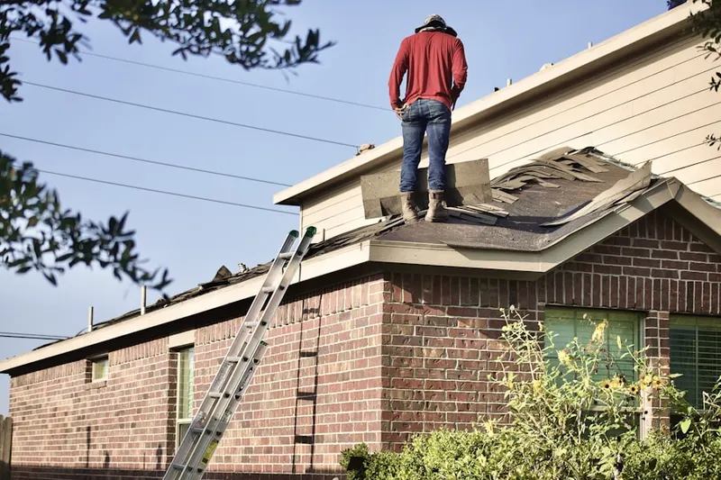 Professional roofer working on a residential roof in Long Branch City